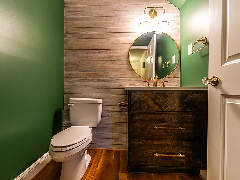 Downstairs half-bath. Custom vanity with accent wall.