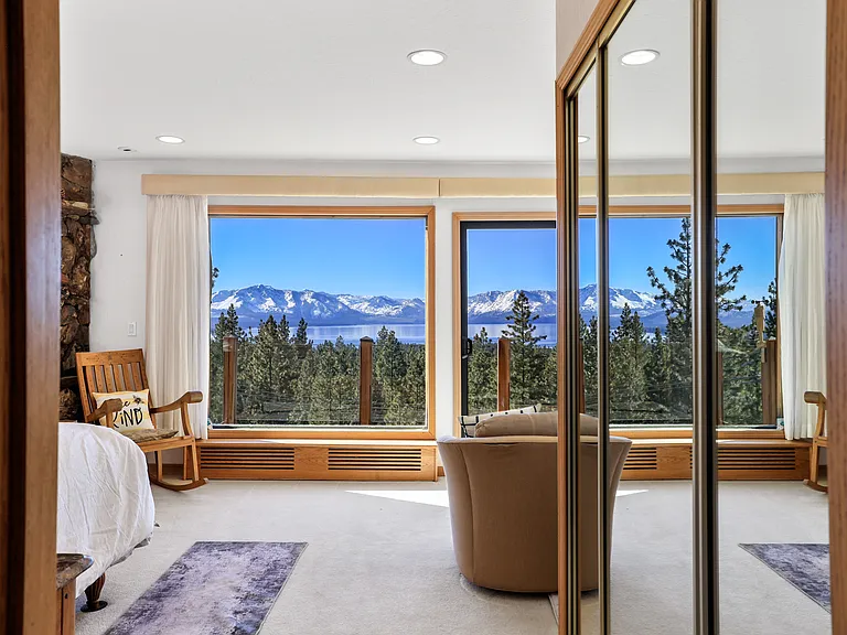 Walking into the master bedroom. There is a deck and a view that is absolutely stunning