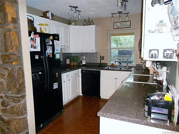 Updated kitchen with great flow.  Wood-like ceramic tile floors, pass through window to covered patio.