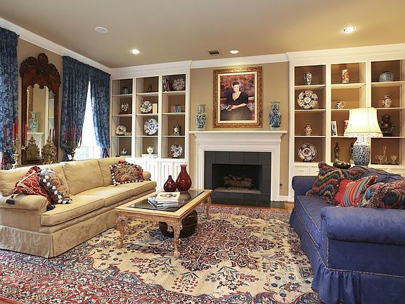Huge formal living room with built in bookcases and wood burning fireplace