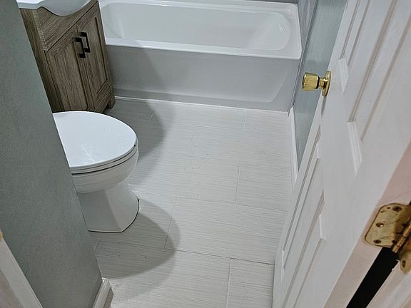 inviting back yard, not shown in this photo is the large space behind the garage to the left