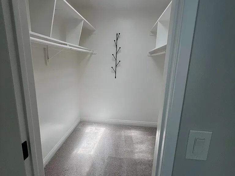 Main bedroom walk in closet with skylight
