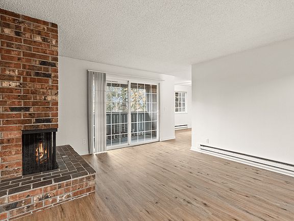 Cozy living room with fireplace and balcony access.