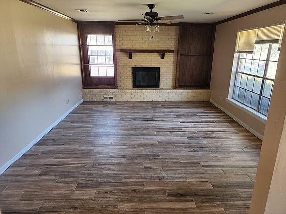 Large living room with large windows for that nice sunshine and a beautiful fireplace.