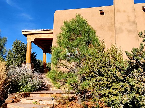 Beautiful entrance to the Front door, greeted by the aroma of pinon & flowers up the stairway.