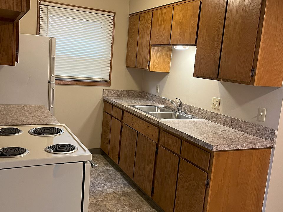 well-lit kitchen with double sink, garbage disposal, generous storage