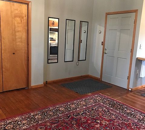 Living Area. Clost door, Entry Door (right), Oriental Carpet, 10-foot ceiling, fan cord shown.