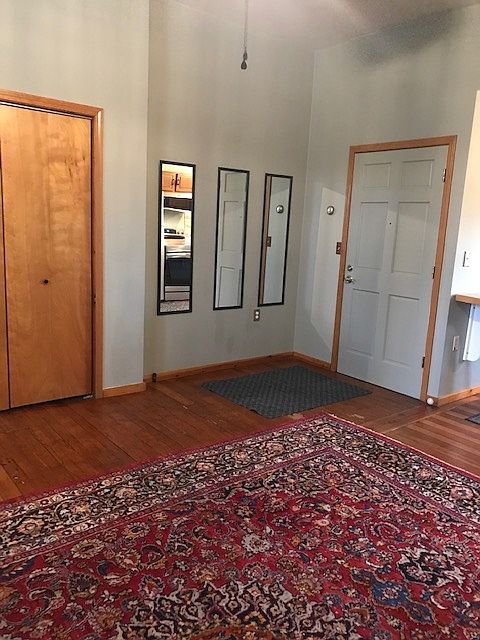Living Area. Clost door, Entry Door (right), Oriental Carpet, 10-foot ceiling, fan cord shown.