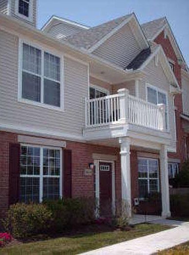Exterior of building. End unit facing pond. Ground floor all on one story.