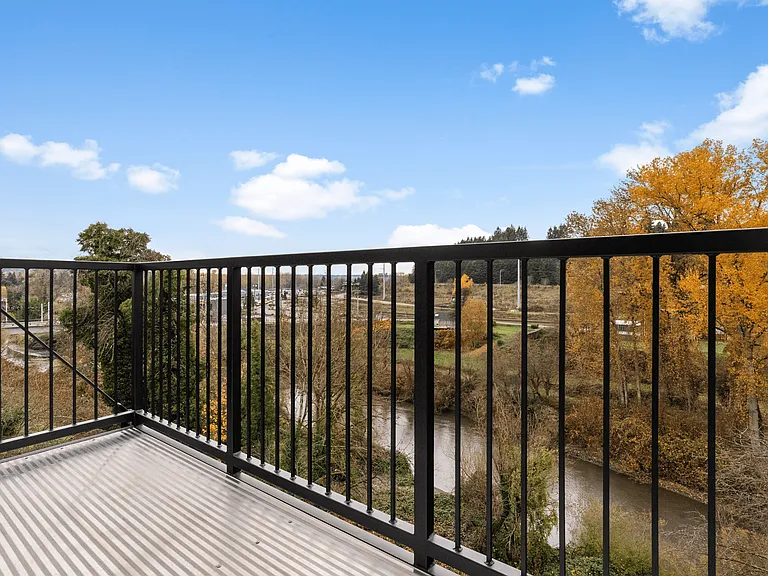 A serene balcony view framed by vibrant fall colors. A serene balcony view framed by vibrant fall colors.