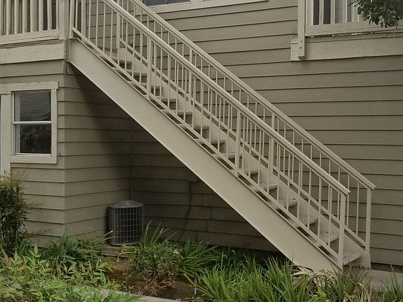 Outside of Apt D, the lower window is the laundry room and the staircase only serves Apt D.