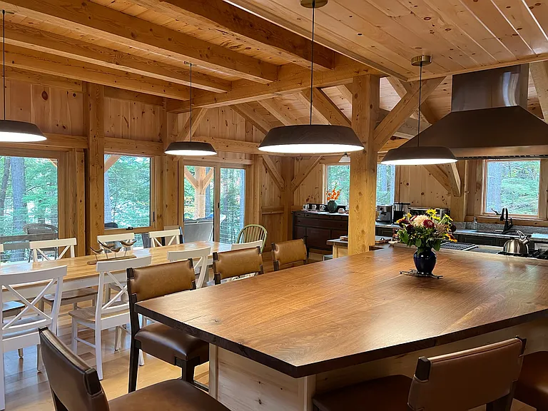 The central kitchen area with an island that seats nine and a table that seats ten.