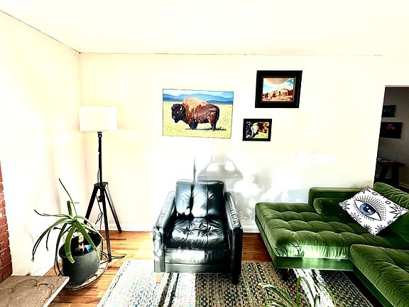 Also a view of the living room facing in from the window. The fireplace has now been painted white where you see the brick. A big screen, new 75 in. TV will be up by October 29.