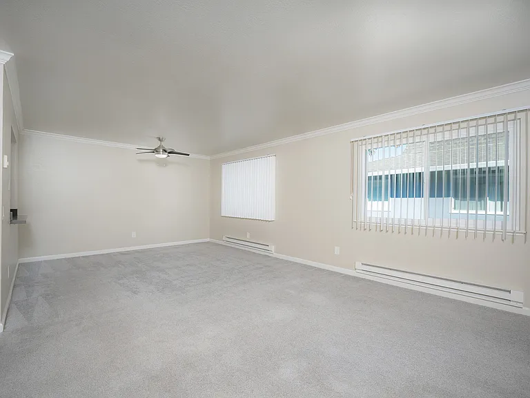 Experience the openness of this modern living room, perfectly lit and ready for your personal touch.