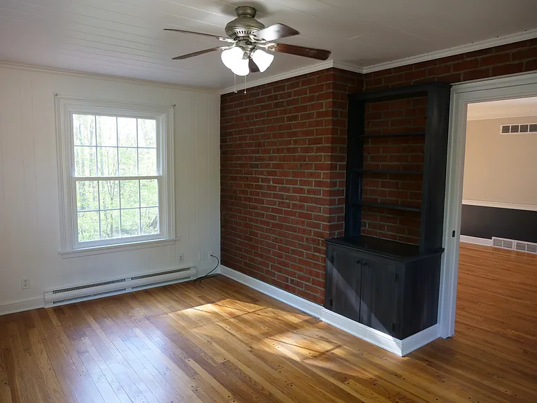 Additional room off living room with beautiful view of Mill Creek Park. Includes exposed brick and shelving.