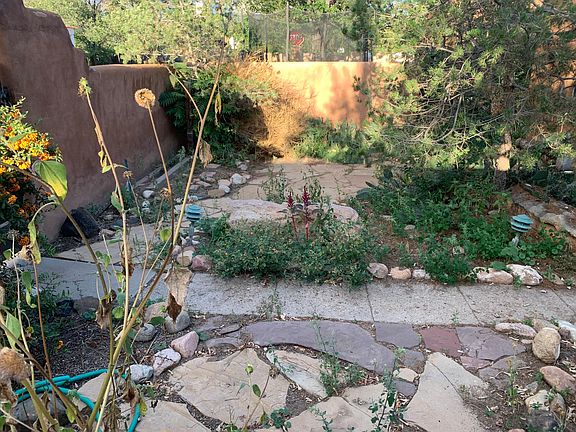 Private front yard with flagstone patio and existing landscaping