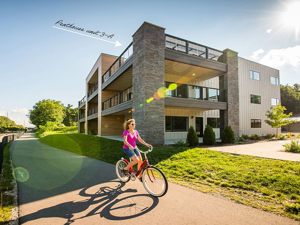 The penthouse is on the top floor of this small condo complex, which is located on the Boardman Lake Loop Trail