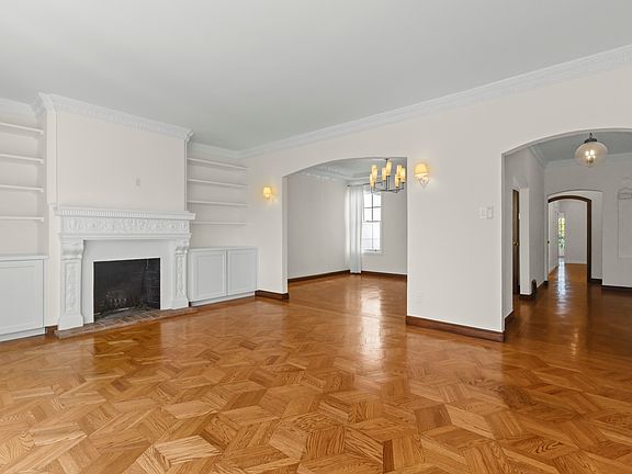 Open floor plan with living room connected to entryway and dining room.