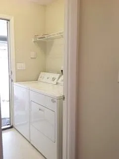 Laundry room with hook up for full size washer and dryer, appliances not included. Tile floor, coat hooks on long wall. Immediately across a short hall from doorway into kitchen _ easy to unload groceries from car to kitchen.