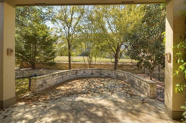 Like a private sanctuary, the back yard with Covered Patio and Stone Terrace, is a shady respite.
