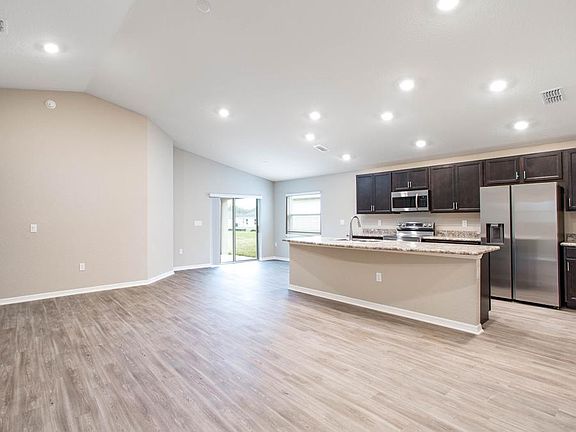 The living area is finished with low-maintenance vinyl plank flooring - Waterfront home for sale in