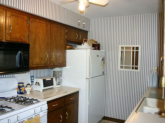 Kitchen features a gas range & built-in microwave. The refrigerator will stay.