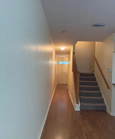 Looking from the living room to the main entrance and to upstairs