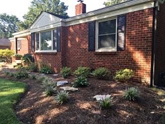 HOUSE: White azaleas , a variety of hosta plants and variegated liriope grow in the front bed. of the house. There are two dogwood trees, one on the south side of house and one in the back yard.