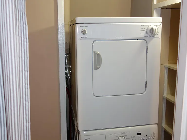 Washer dryer with pantry shelves on right side.