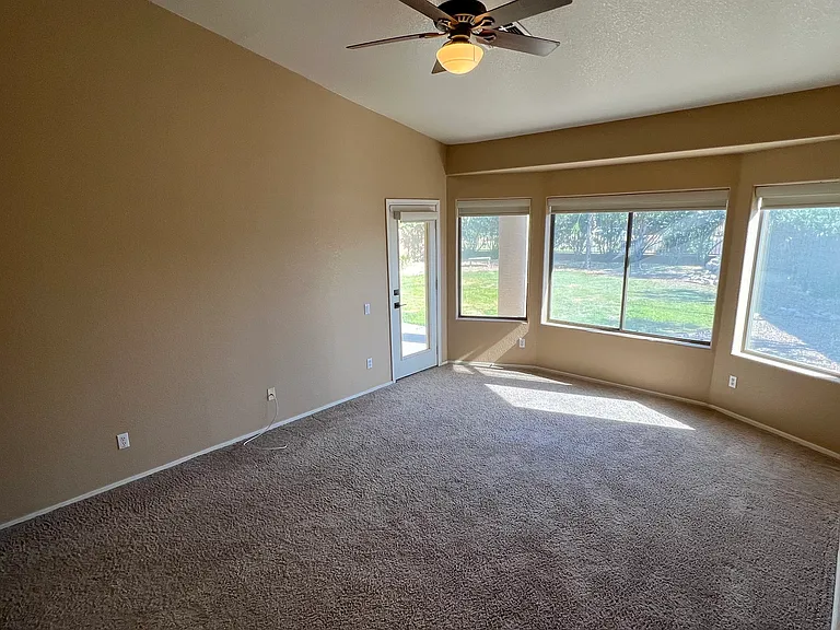 master bedroom on first floor with access to patio, private full bathroom and closet
