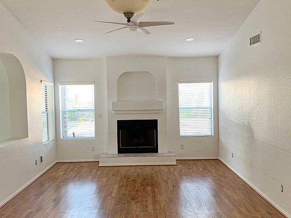 Entry way into living room w/ wood burning fireplace