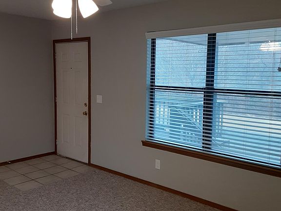 View of the living room featuring the new ceiling fan.
