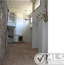 Entry, dining room and living room have a brick feature wall.