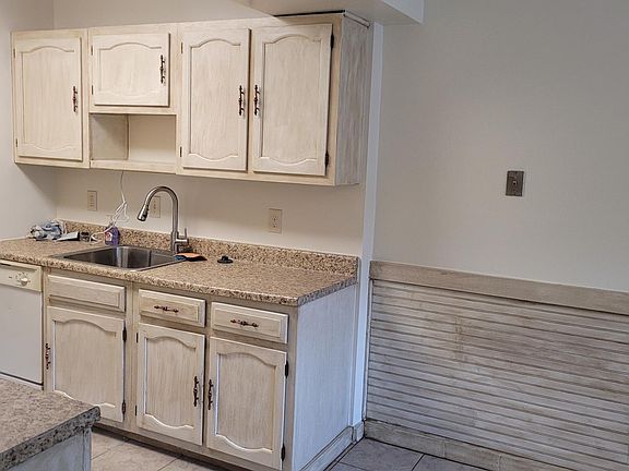 Right side of kitchen with deep sink and disposal, and showing former dishwasher since replaced this year with a new one. Beyond that to left in the picture is a pantry.