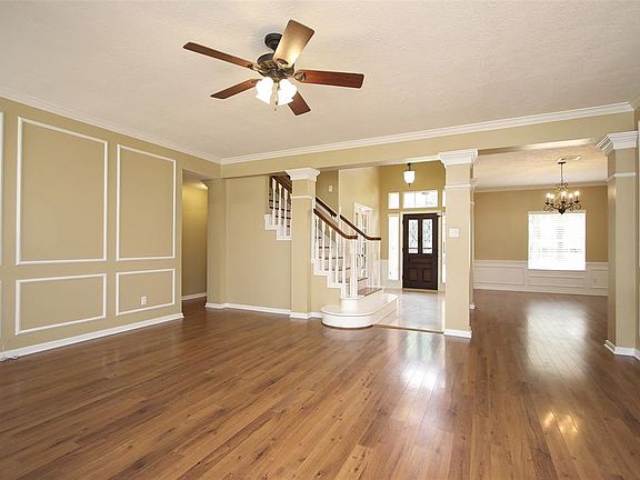 The hardwood flooring flows from the formal dining room into this large family room.
