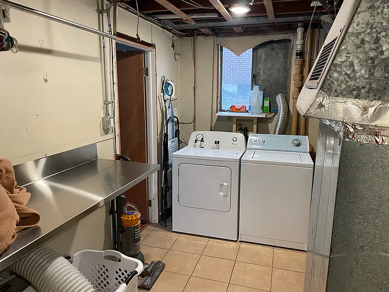 Shared Laundry with folding table and hanging bar. Easy access door to lower unit living room (to the left)