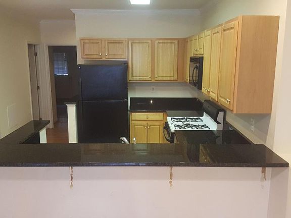 Kitchen with wrap around new granite countertop and barstools