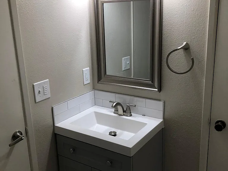 Remodeled Bathroom with New Lavatory with Tile Back Splash (July 2022)