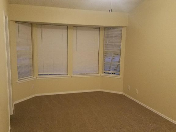 Large Master Bedroom with bay window. The entry into the master bath is off to left of picture.