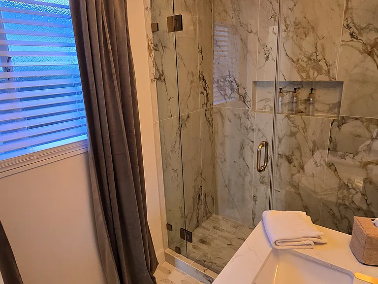 Shower niche for holding bathing necessities, freshly painted throughout with bright white designer shades.
