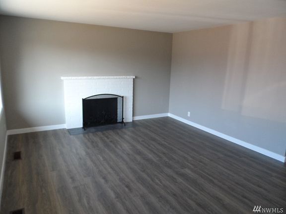 Large family room with new laminate flooring, paint and trim.