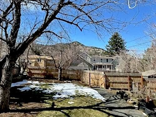Fenced in back yard with parking area behind fence off of alley