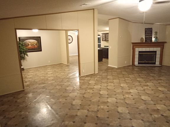 From the front door overlooking at a spacious living room area overlooking the dining room and the kitchen area.