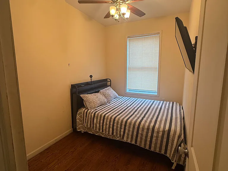 Private bedroom 1, hardwood floors, ceiling fan with light, window with blinds for comfort. Dresser available, room for desk