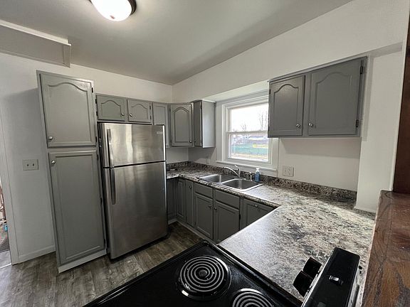 Kitchen with stainless steel appliances - refrigerator and electric stove