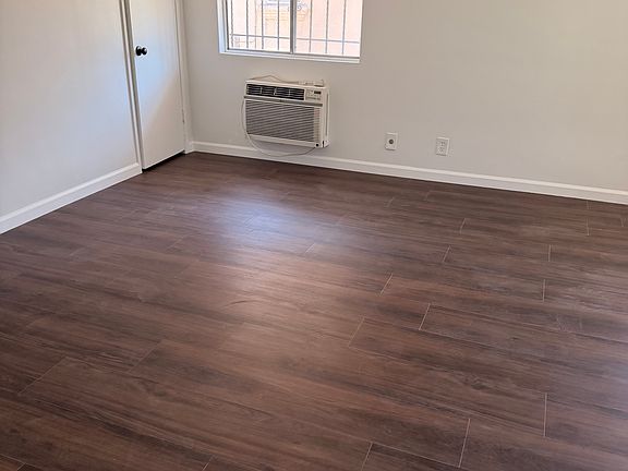 Livingroom with multipurpose utility room tailored for cleaning supplies, etc.