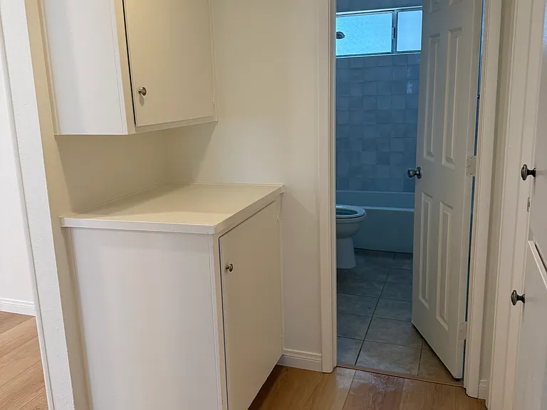 HALLWAY WITH PLENTY OF STORAGE/LINEN CABINETS