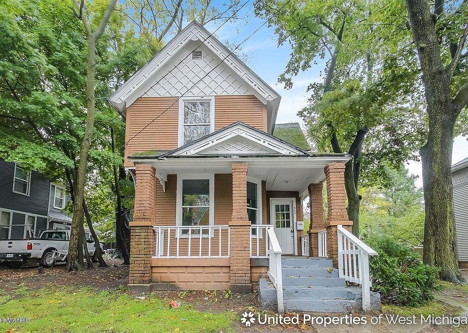 Street view of the house and porch. Parking pad for 2 cars located to the right of the house.