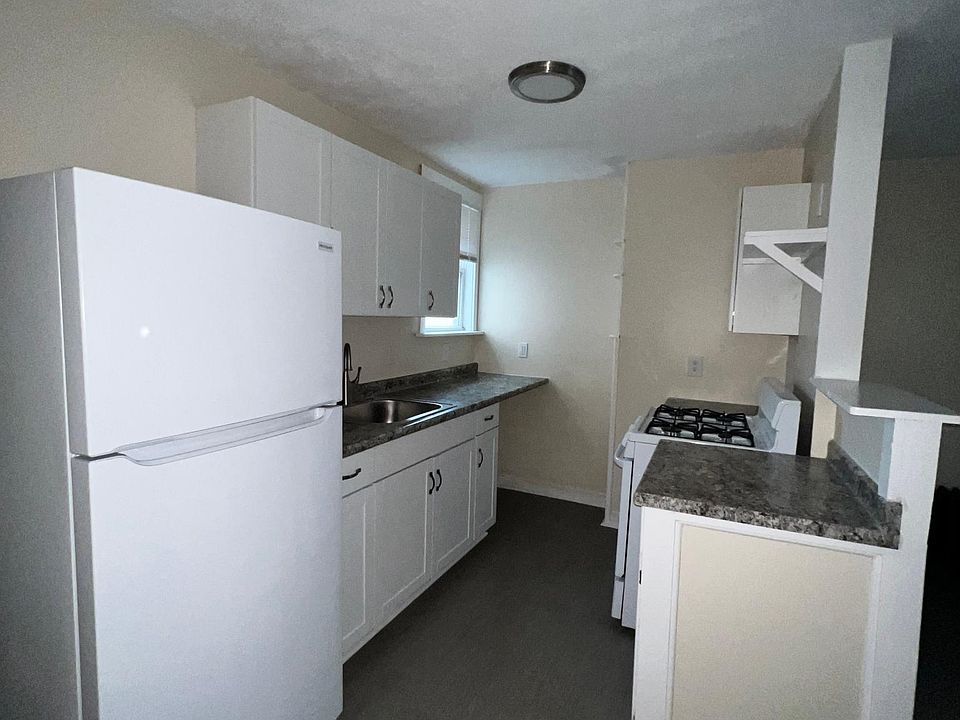 Galley Kitchen has new appliances, counters, and cabinets.