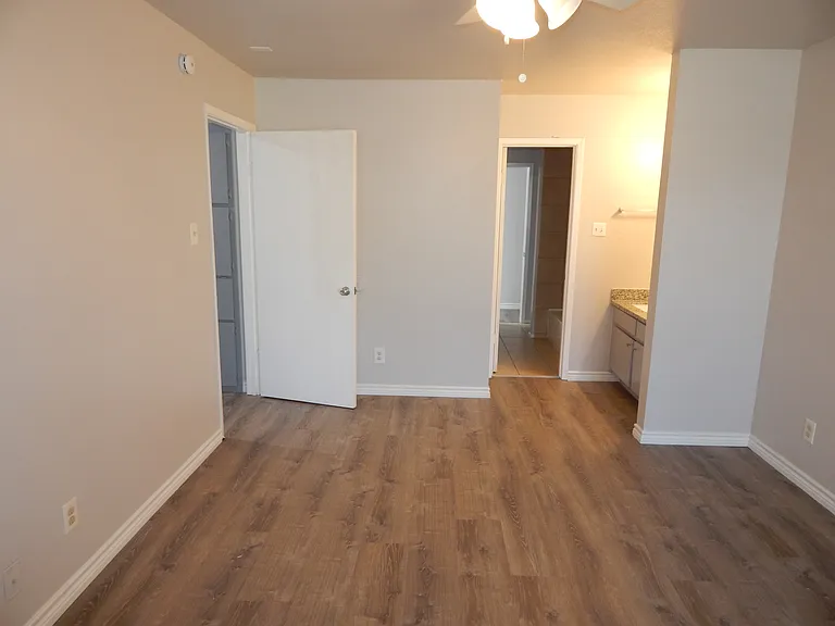 Townhome master bedroom with view to vanity and bath.